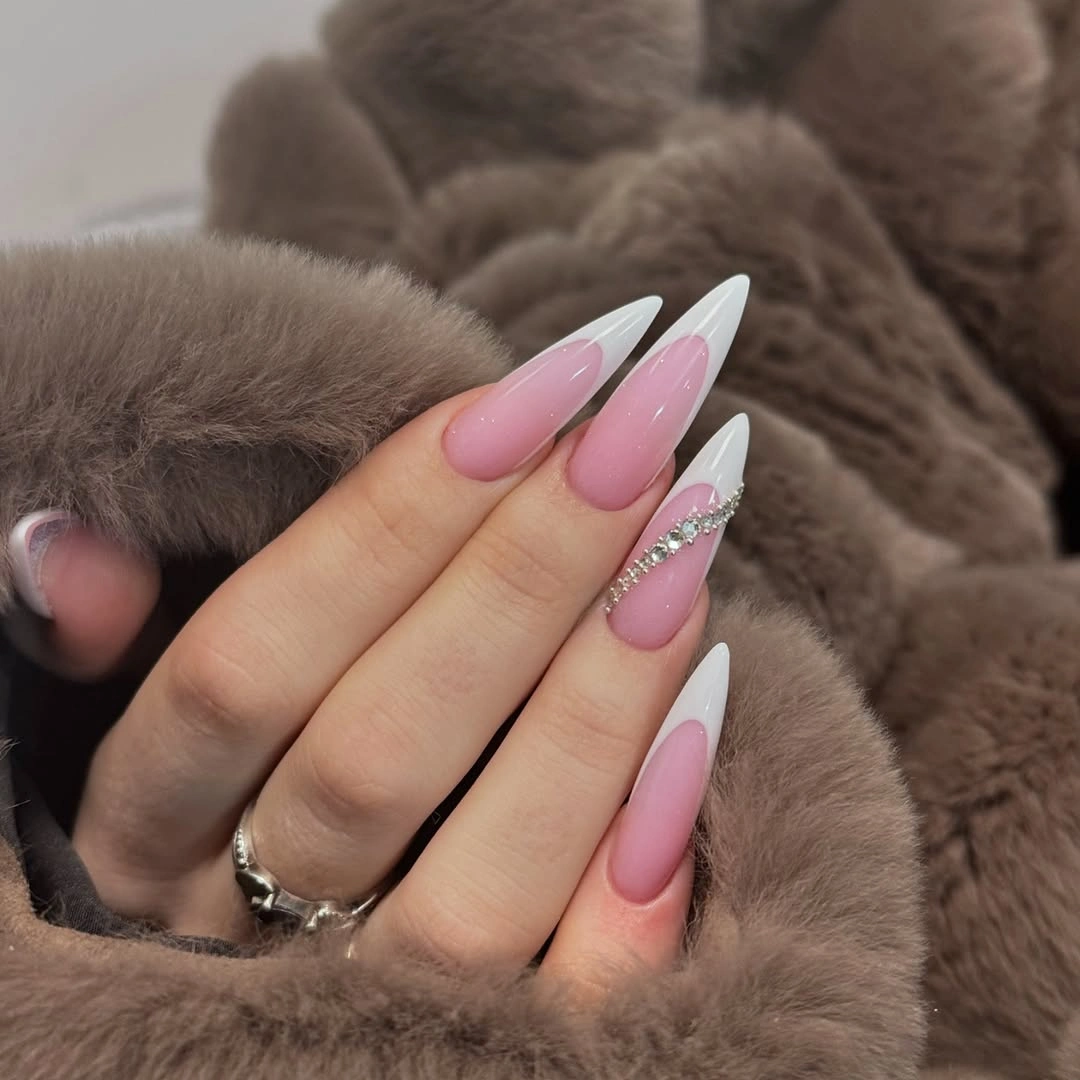 Pointed pink French nails with rhinestone band