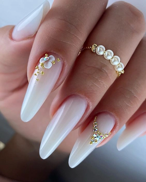 Long almond nails with golden crystal clusters