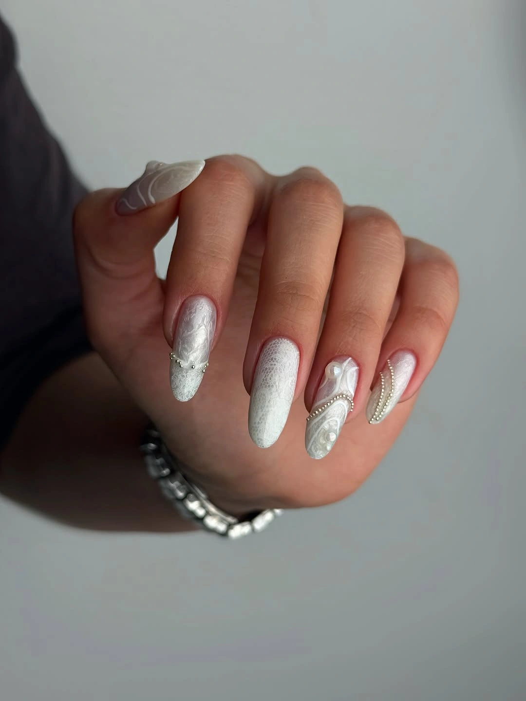 White almond nails with pearl and lace texture