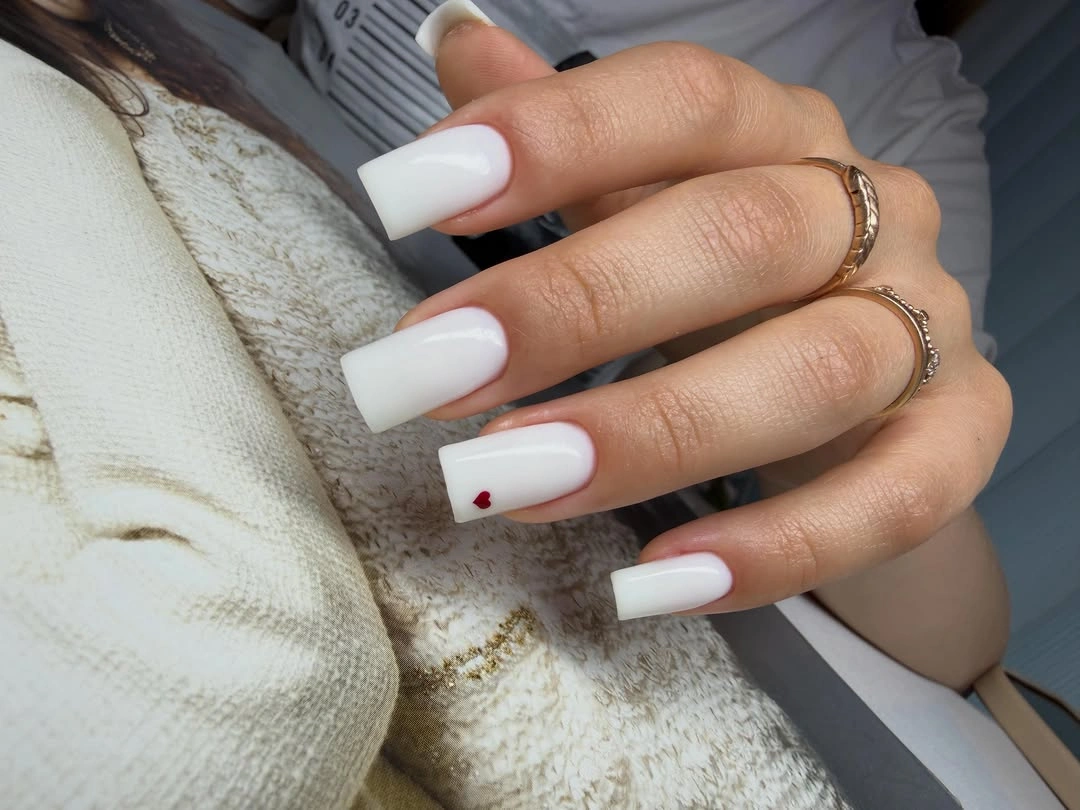 Long white square nails with tiny red heart