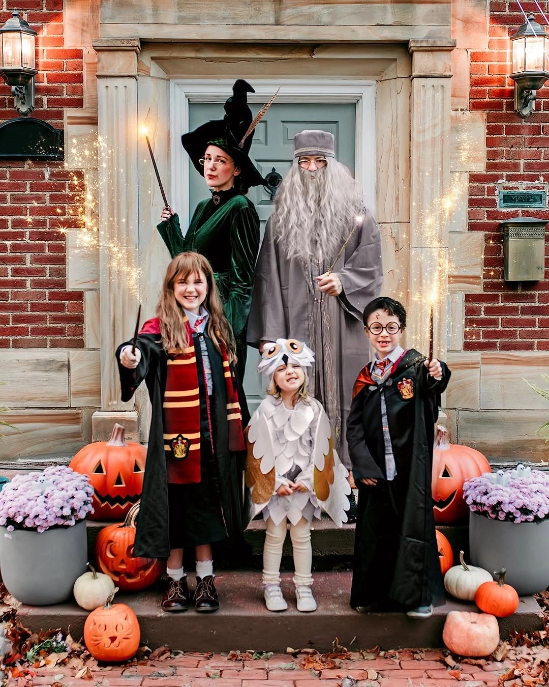 Family witch and gray beard costumes at a porch with pumpkins