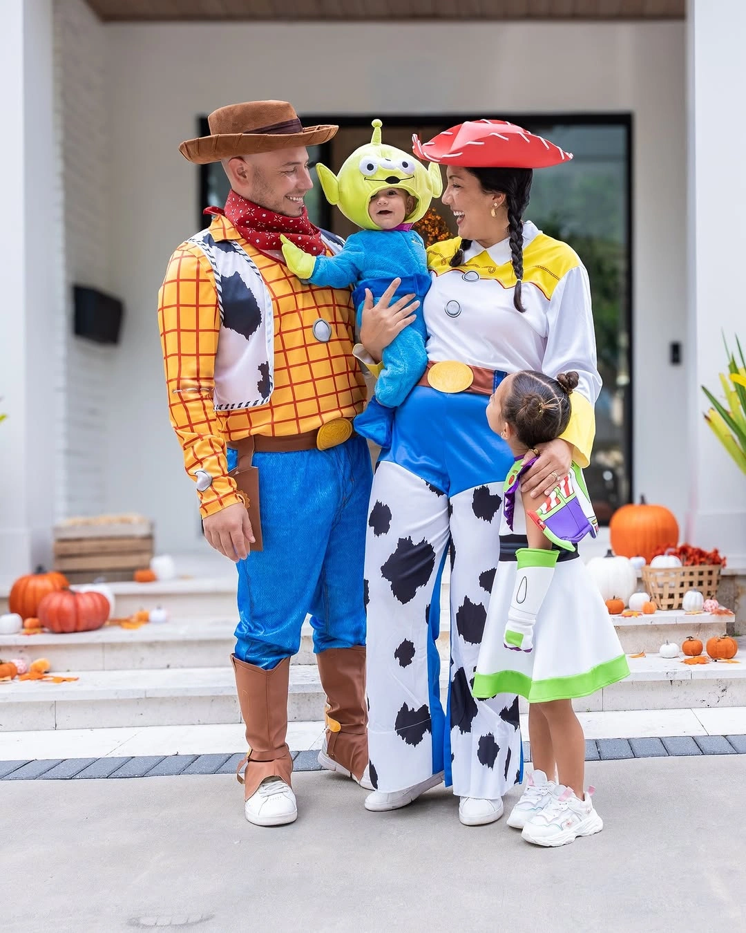 Stone age family costumes with black white tunics and green child outfit