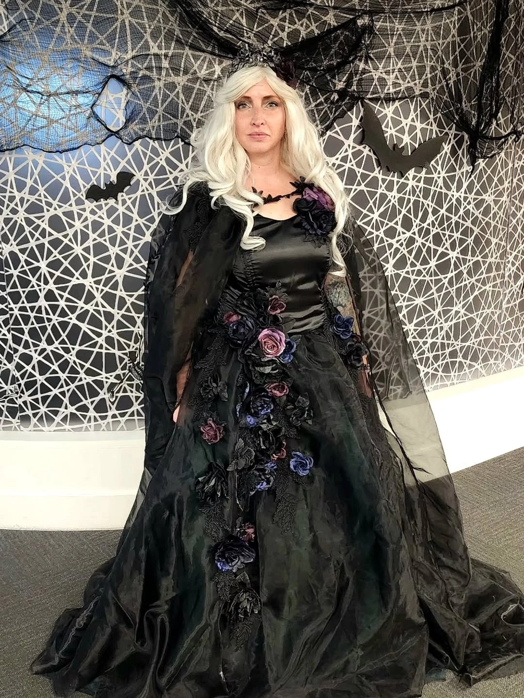 Girl in black floral gothic gown with pale wig sheer sleeves and dark skirt