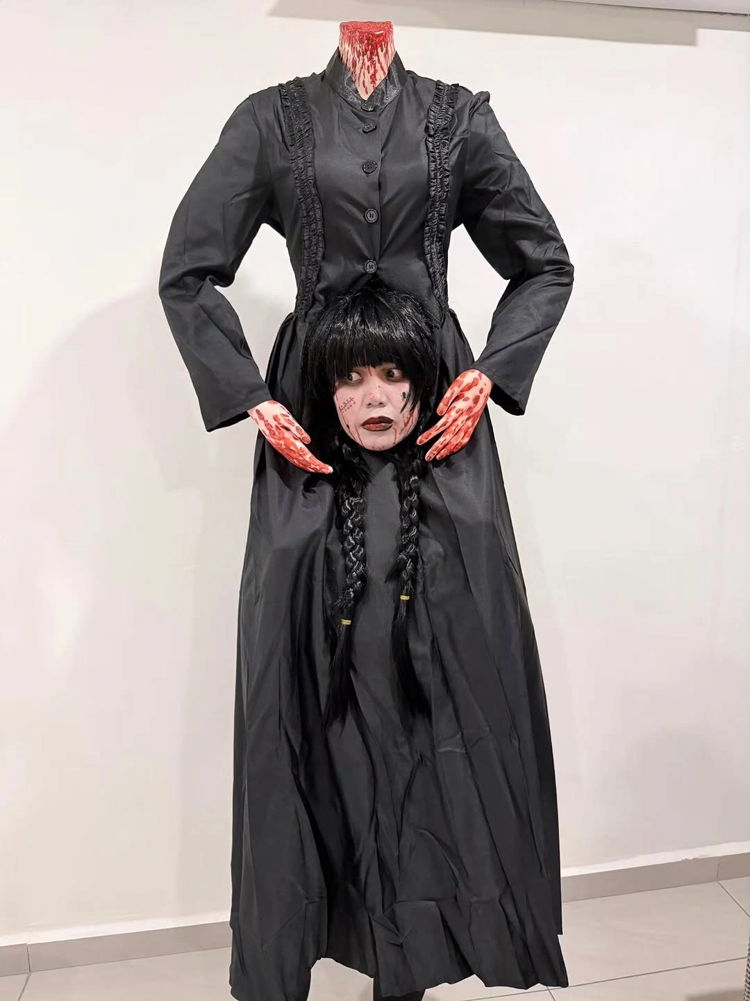 Long black braided costume dress with buttons and pale hands