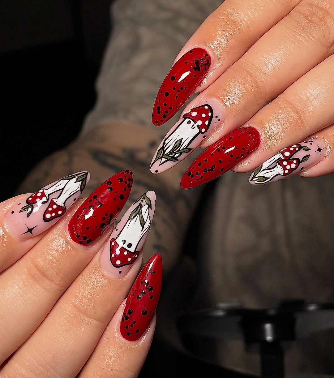 Long red white and black almond Halloween nails with cartoon ghosts, dots, and mixed graphics
