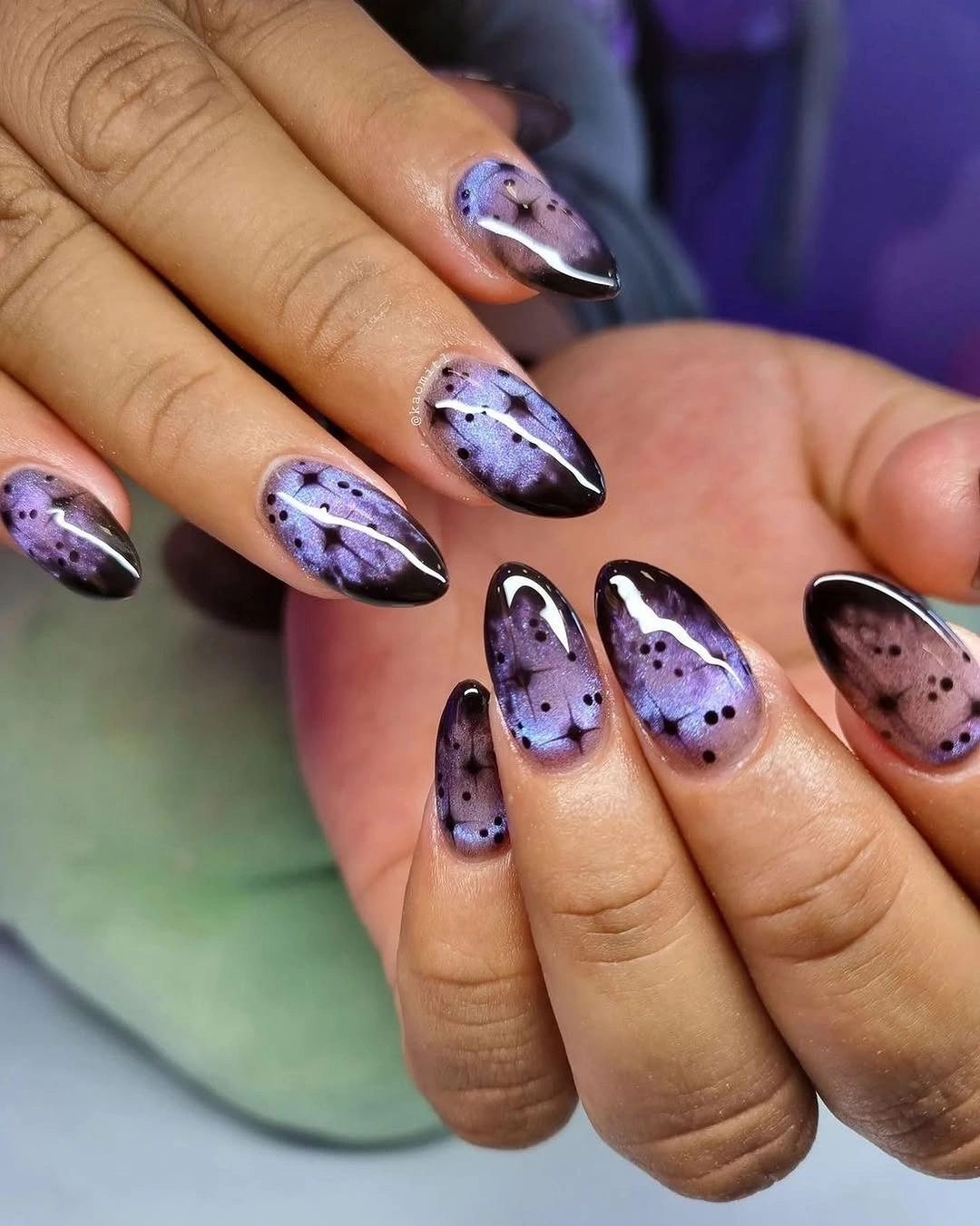 Medium lilac and purple almond Halloween nails with black dots and a glossy ghost silhouette