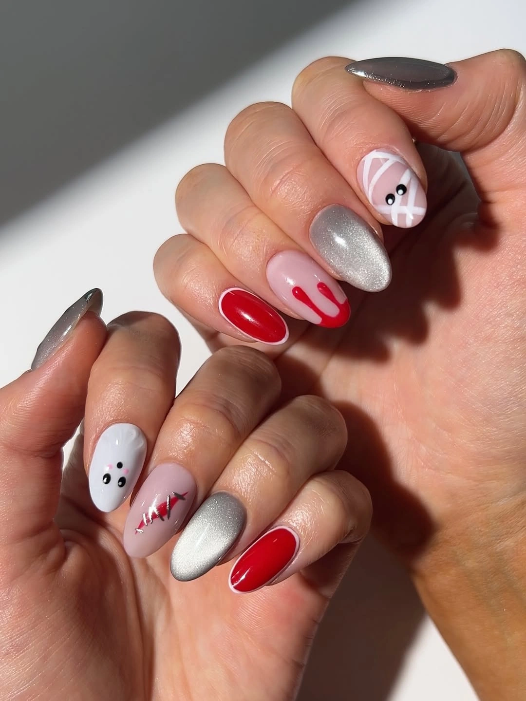 Short to medium red white and silver Halloween nails with ghosts and black details