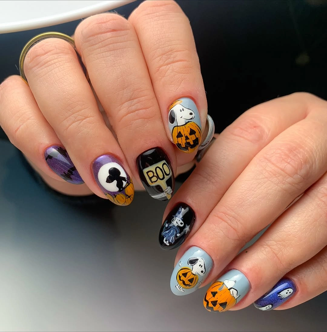 Cool gray Halloween nails with pumpkins graphic faces and black white motifs