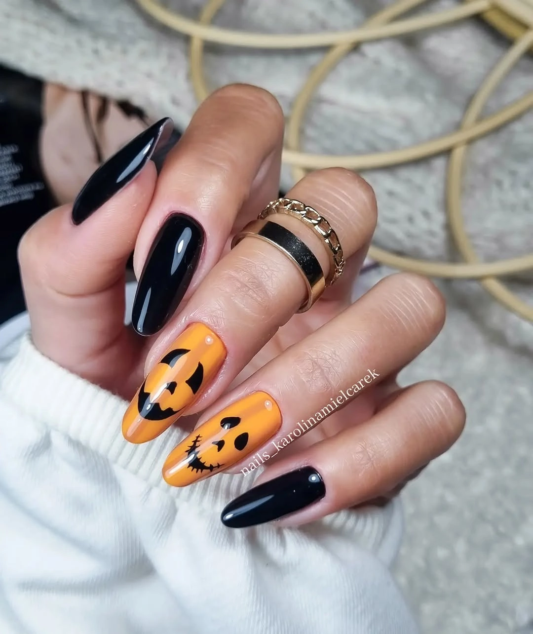 Long black nails with orange jack o lantern French tips and cat faces