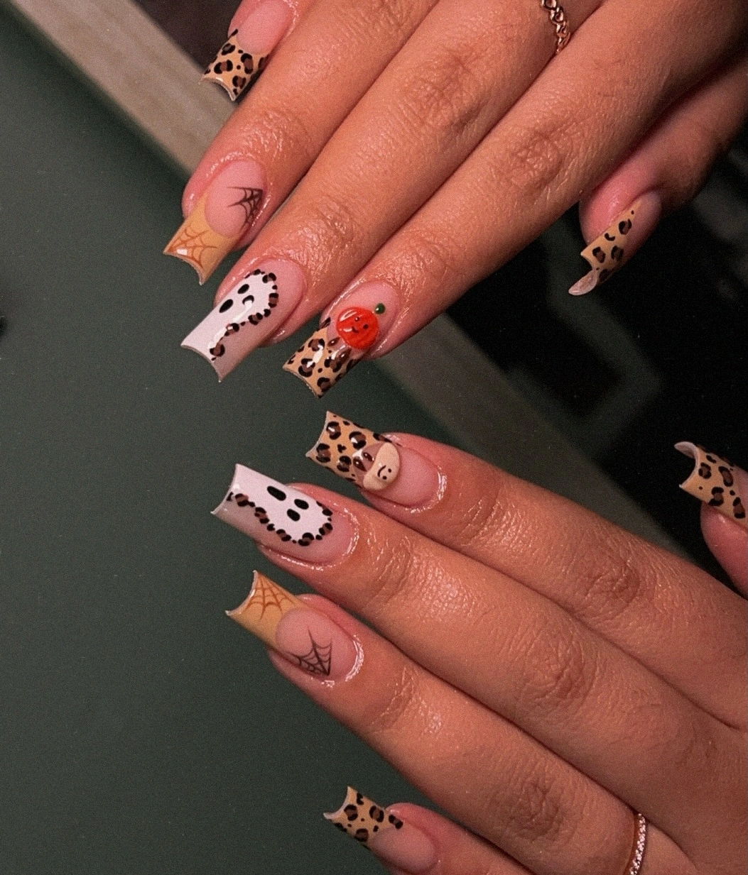 Peach pink nails with ghosts leopard marks spider lines and orange details