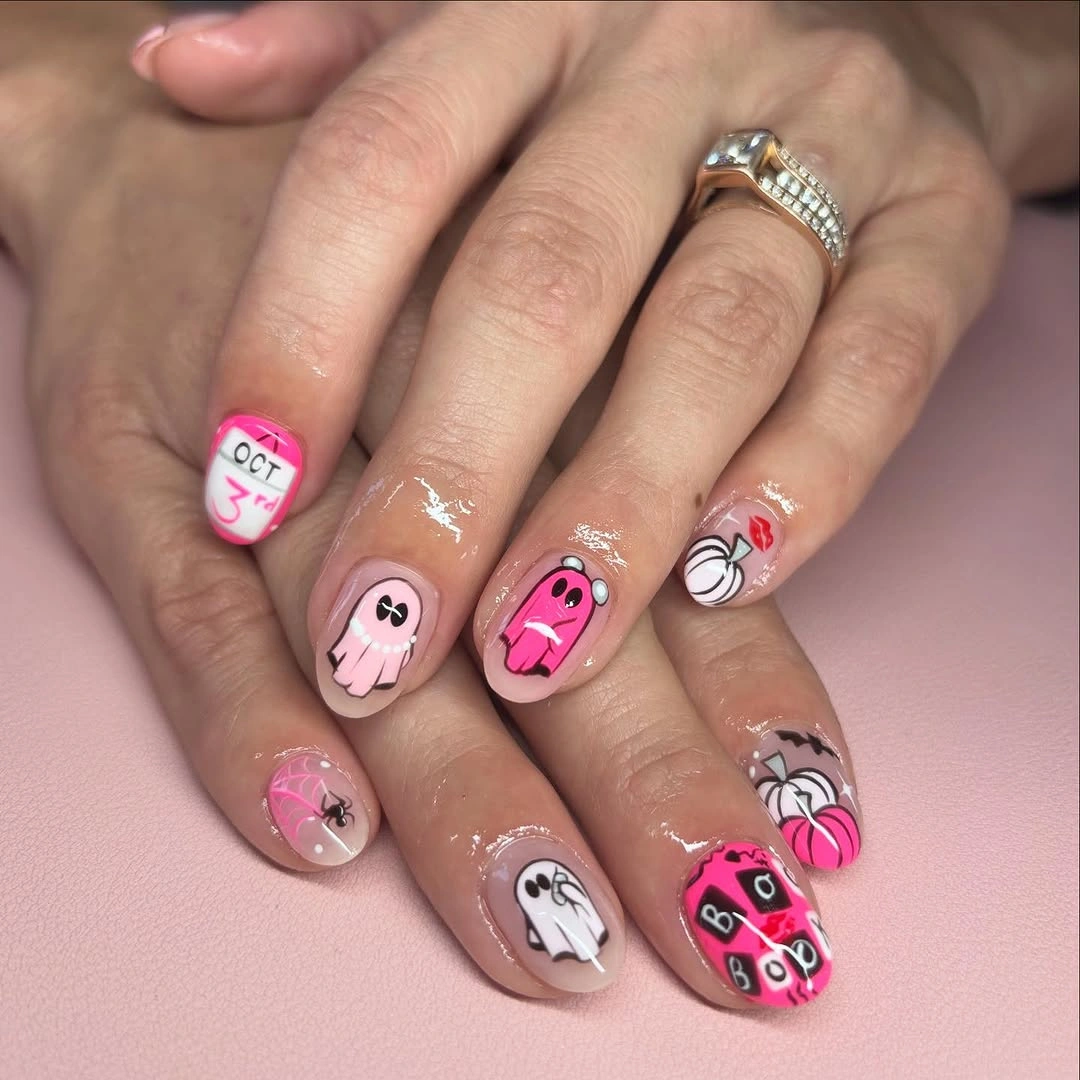 Pink nails with cartoon ghost pumpkin heart and graphic Halloween art