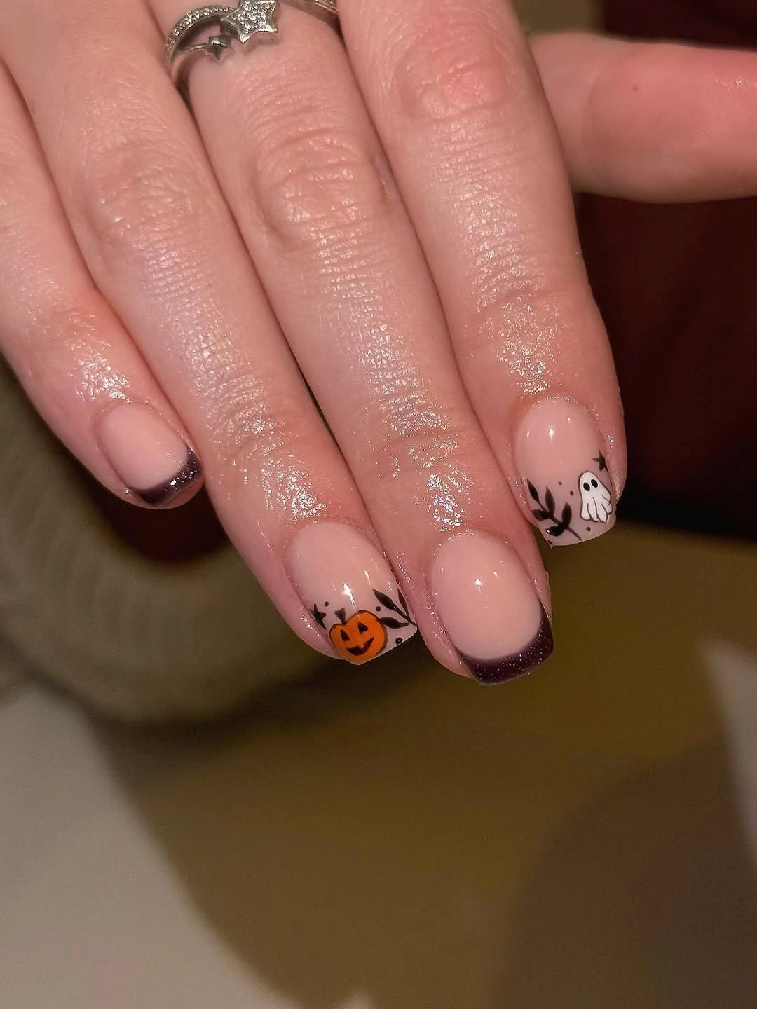 Nude nails with black French tips skeletal ghosts and pumpkin art