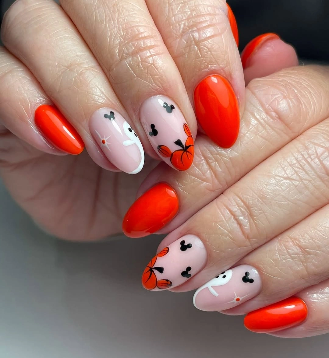 Bright red nails with pale ghost pumpkin heart accent art