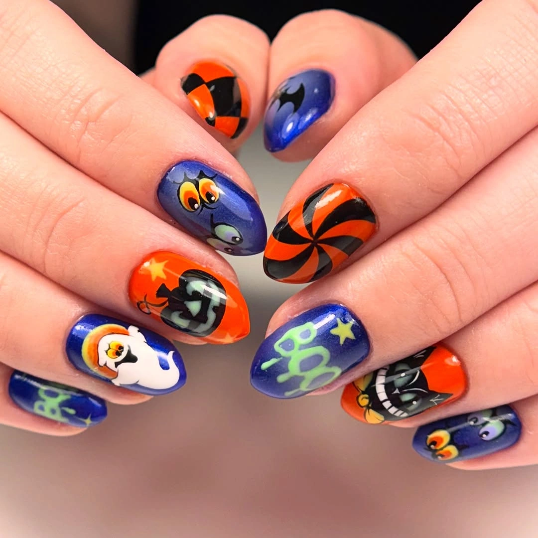 Blue black nails with orange swirls stars and cartoon Halloween art
