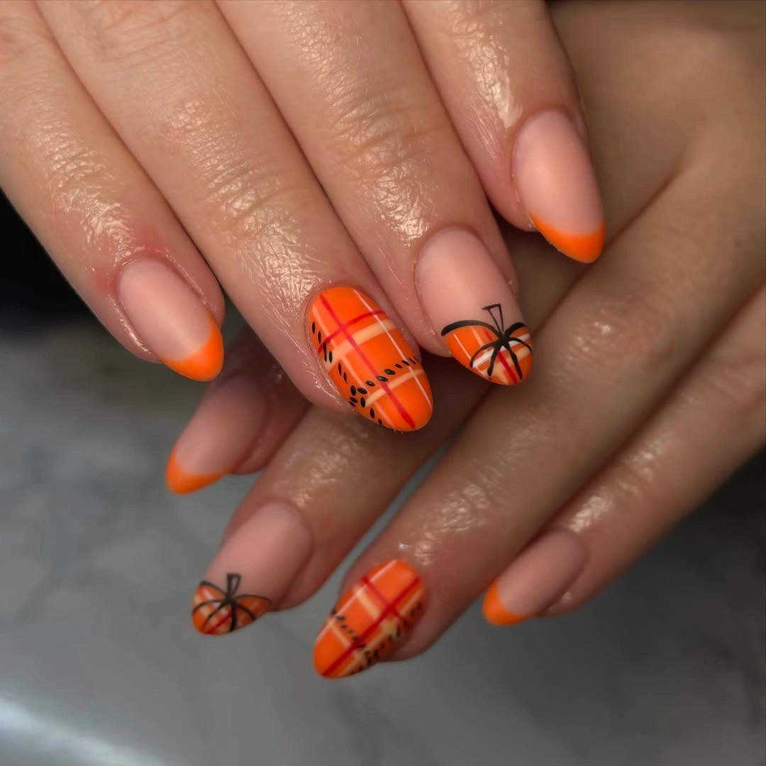 Nude nails with orange plaid panels pumpkin lines and French tips