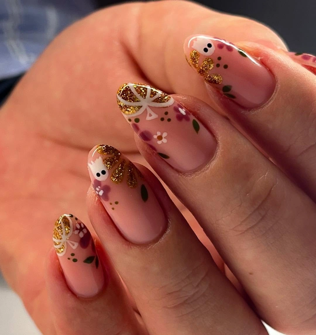 Sheer nude nails with gold glitter edges leaves and tiny pumpkins