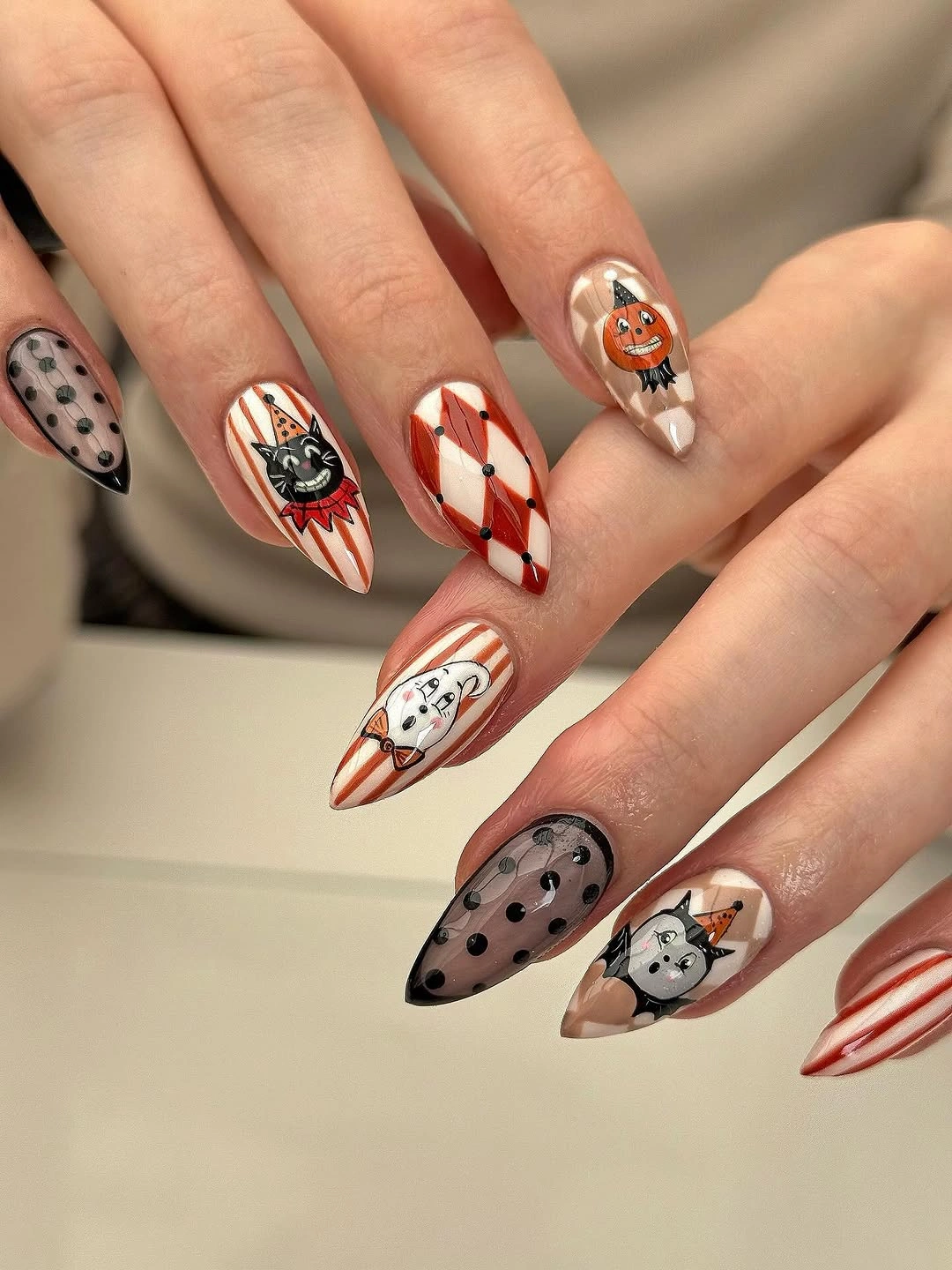 Long almond white pink and orange Halloween nails with cats, ghosts, and stripe graphics