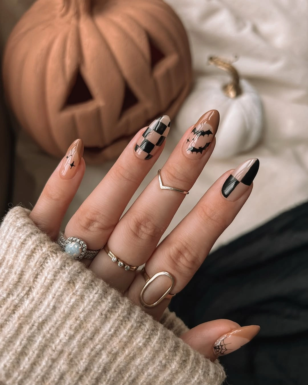 Long almond nude black and orange Halloween nails with pumpkin and ghost linework