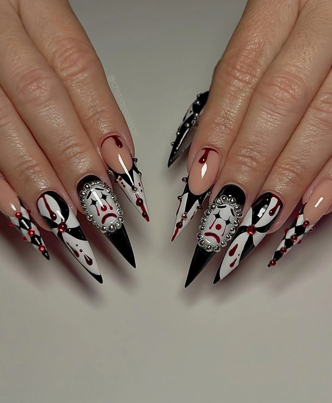 Long ornate black white and red Halloween stiletto nails with ghosts, studs, and symmetrical graphics