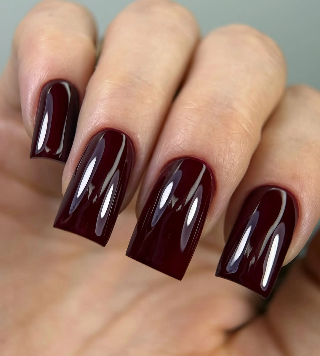 Long square nails in glossy black cherry burgundy