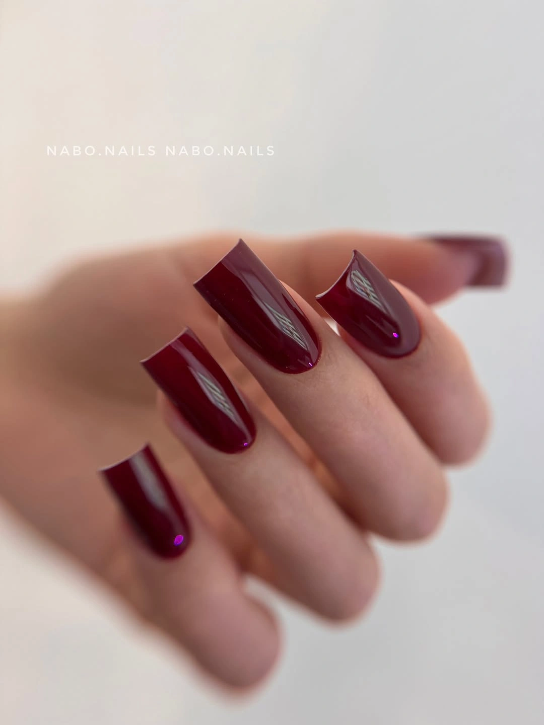 Long tapered square nails in glossy deep wine maroon