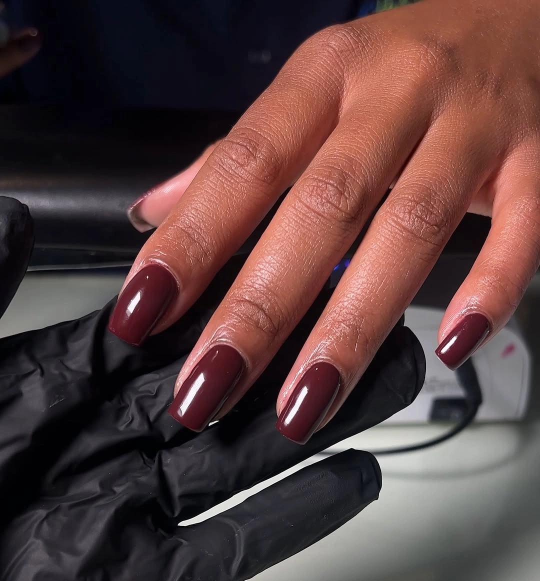 Long square nails in rich glossy burgundy maroon