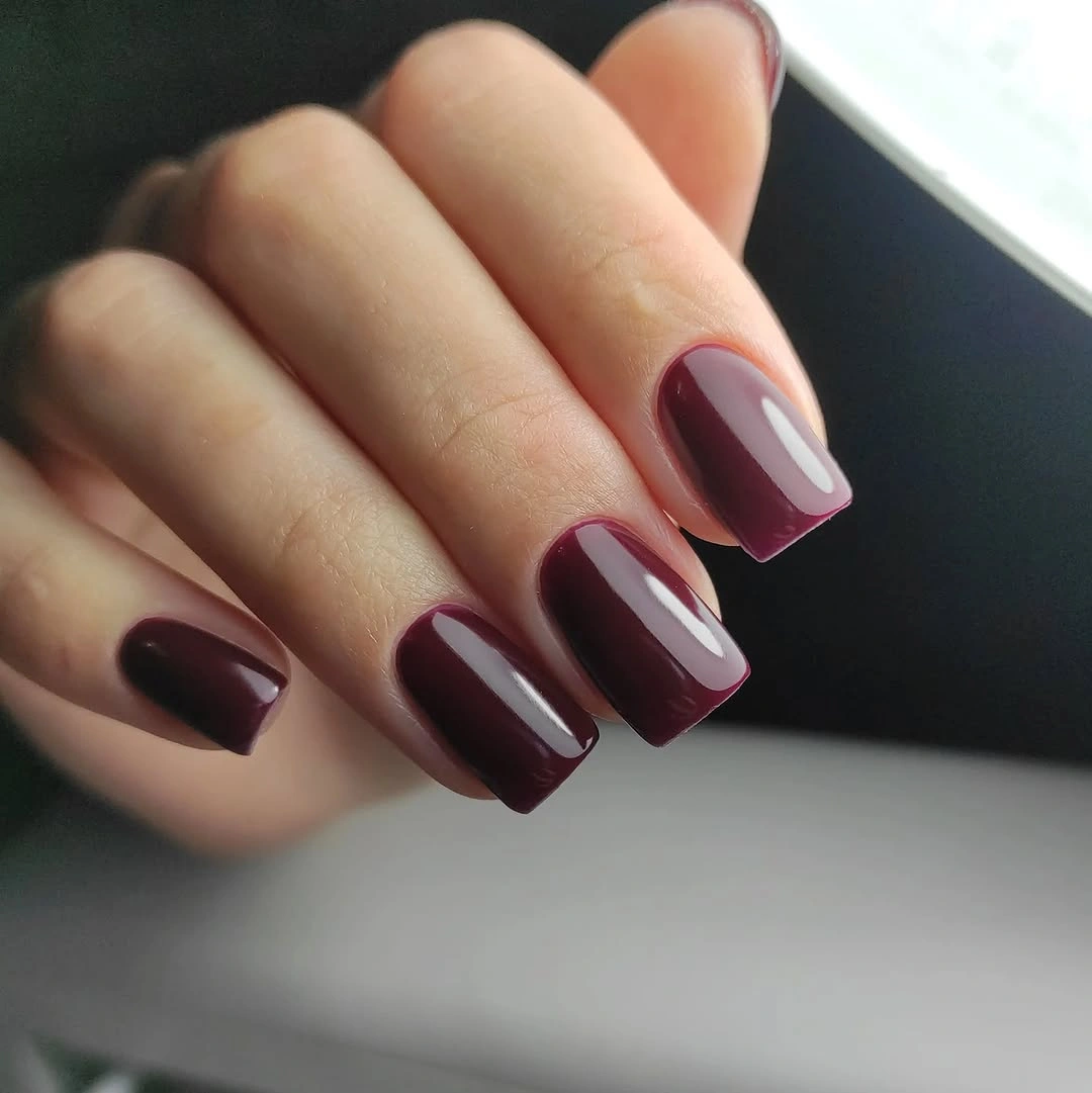 Short square burgundy nails with subtle shadowed edge
