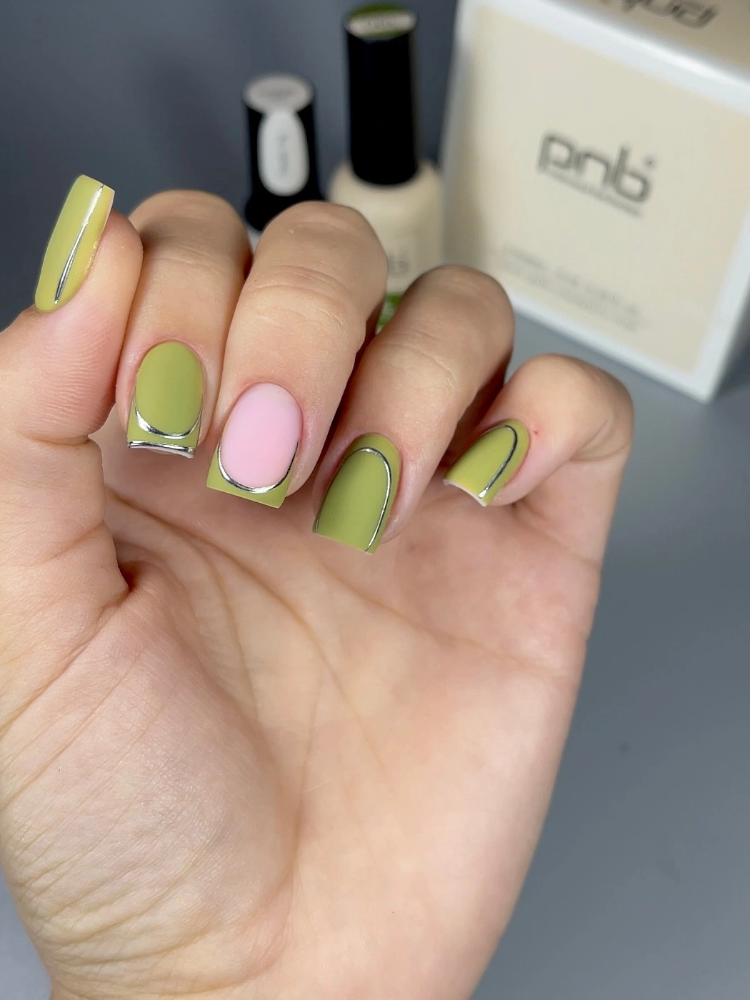 Short square nails in lime and blush pink with thin outlines