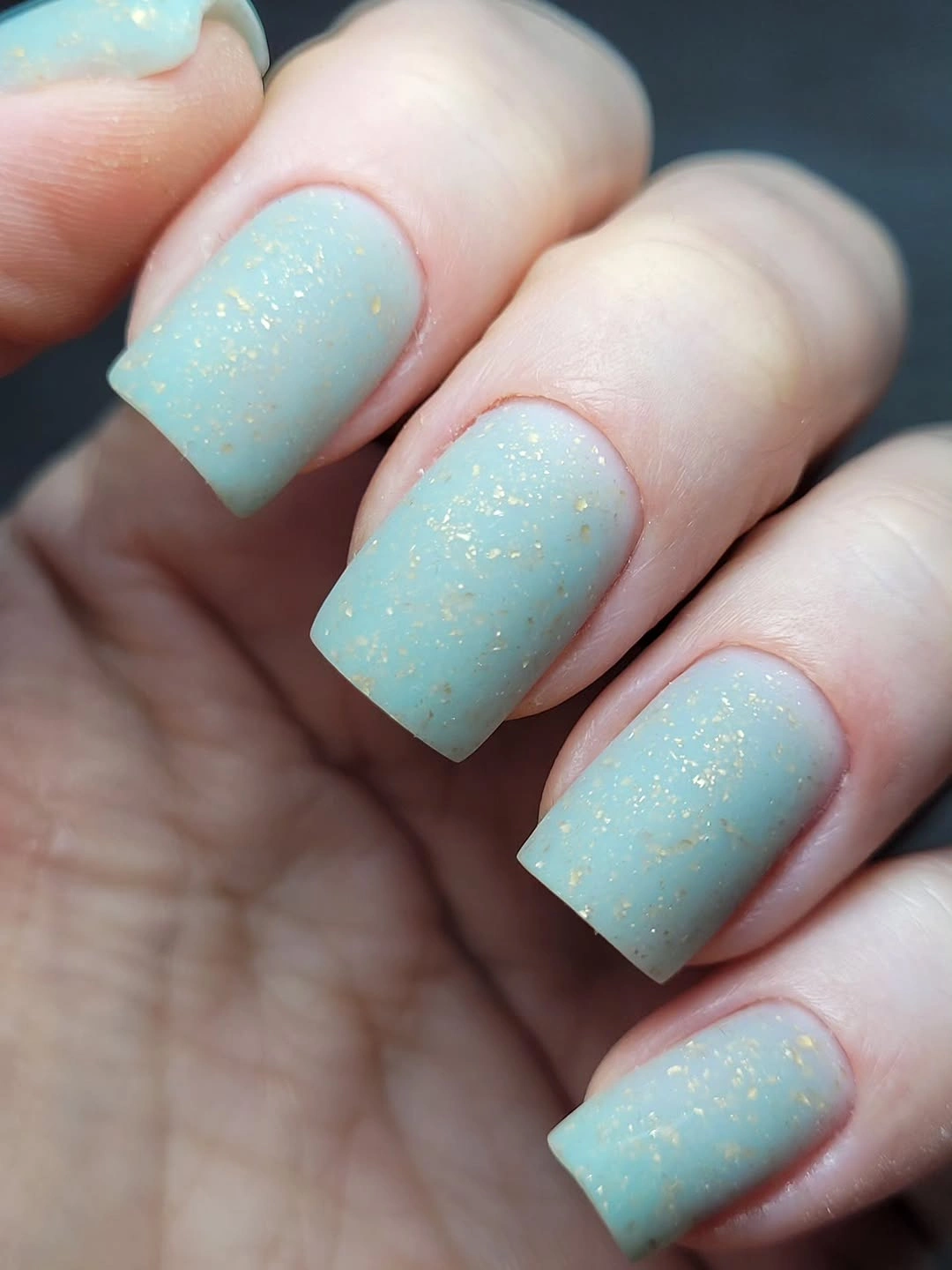 Pale aqua square nails with delicate fine gold shimmer