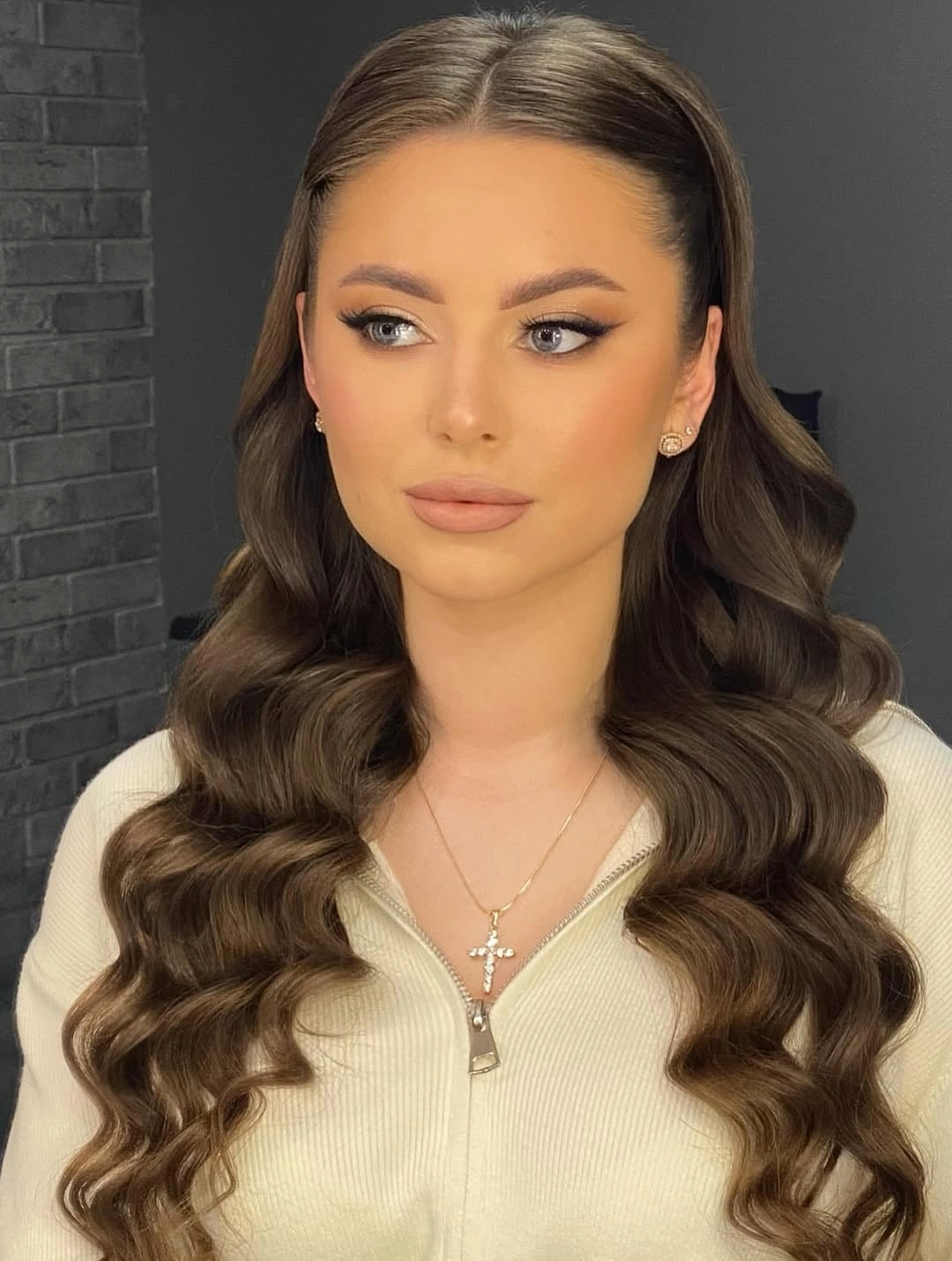 Long brunette hair in defined center-parted waves