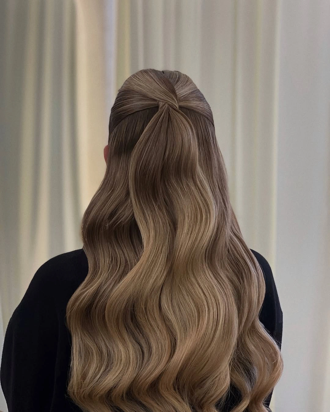 Ash-brown center-parted waves with a small half-up section