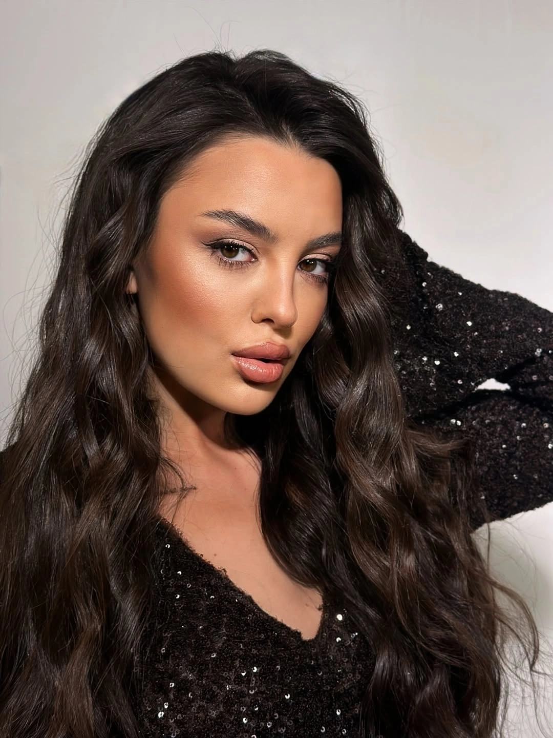 Very long dark center-parted hair with full waves