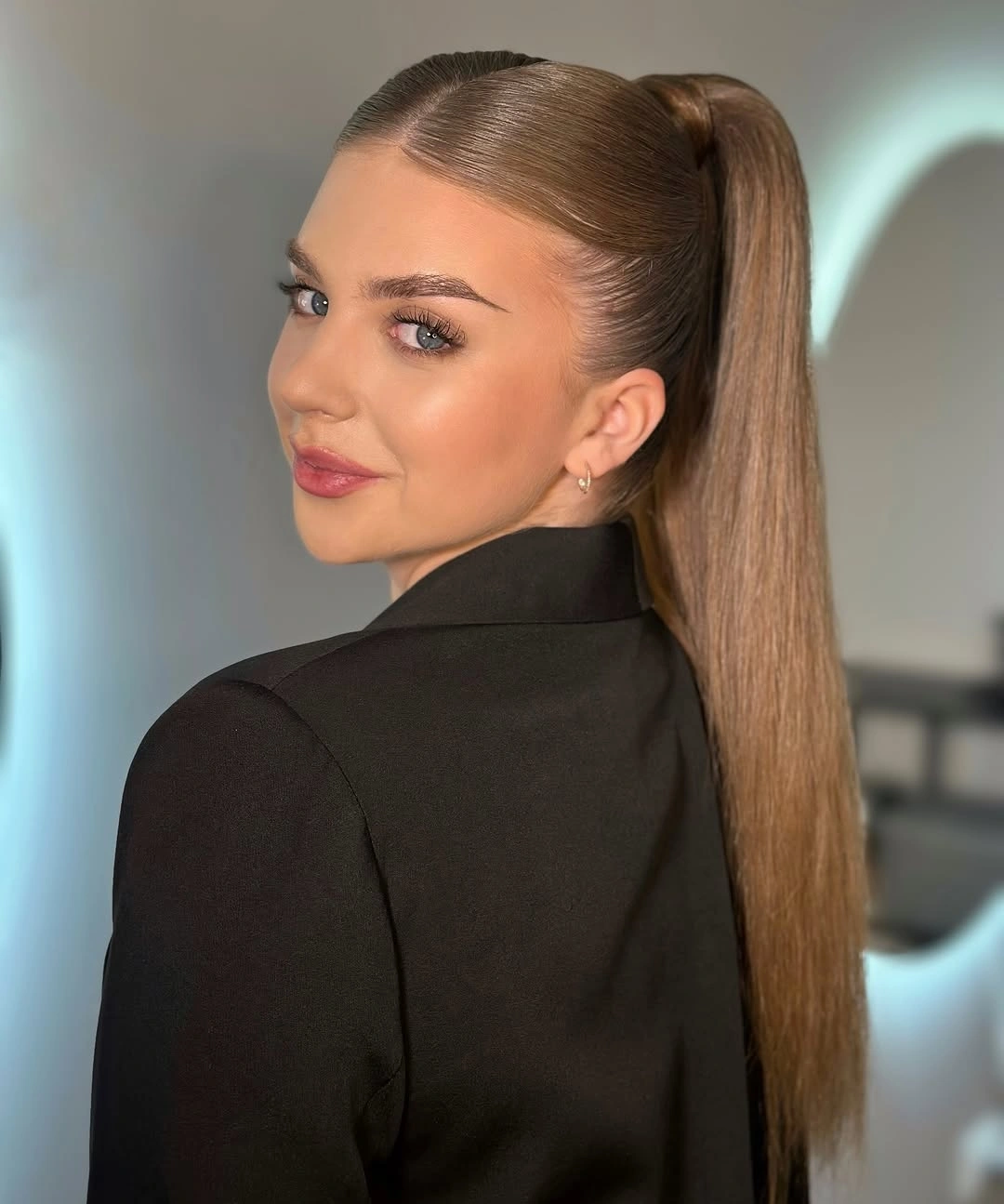 Sleek light-brown high ponytail with a centered crown