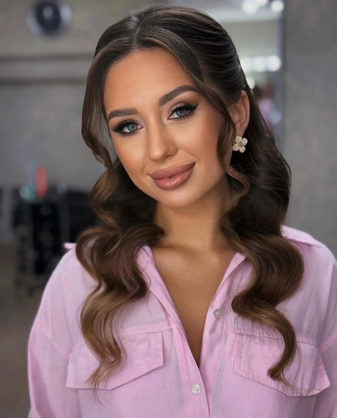 Long brown hair with a smooth center part and soft bends