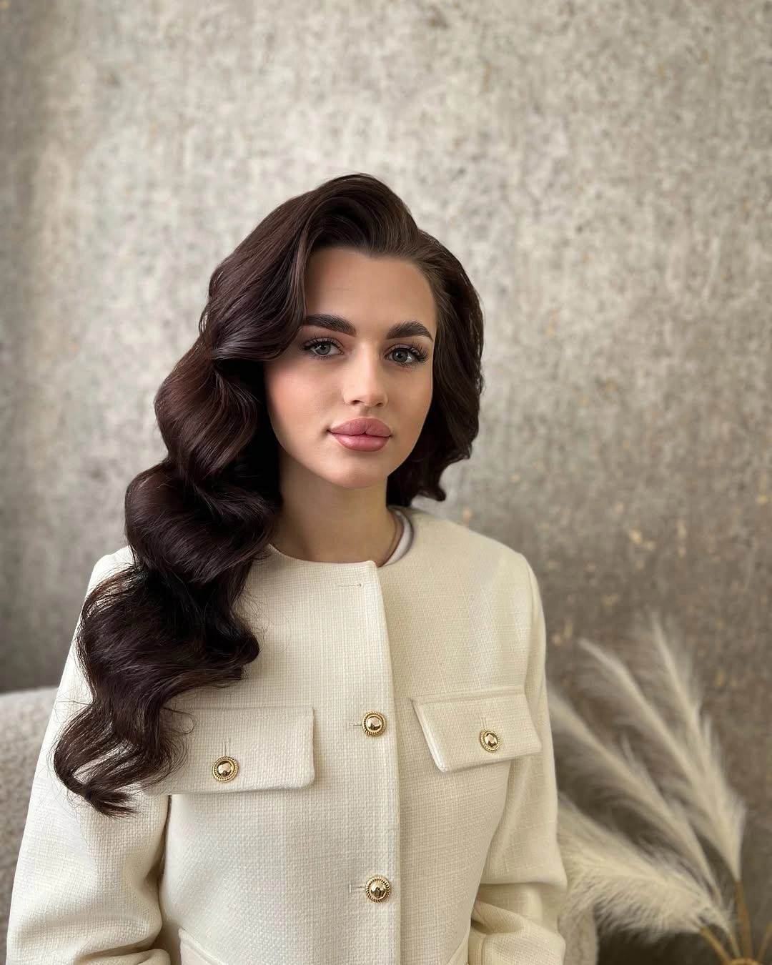 Dark brunette center-parted hair swept into deep side waves