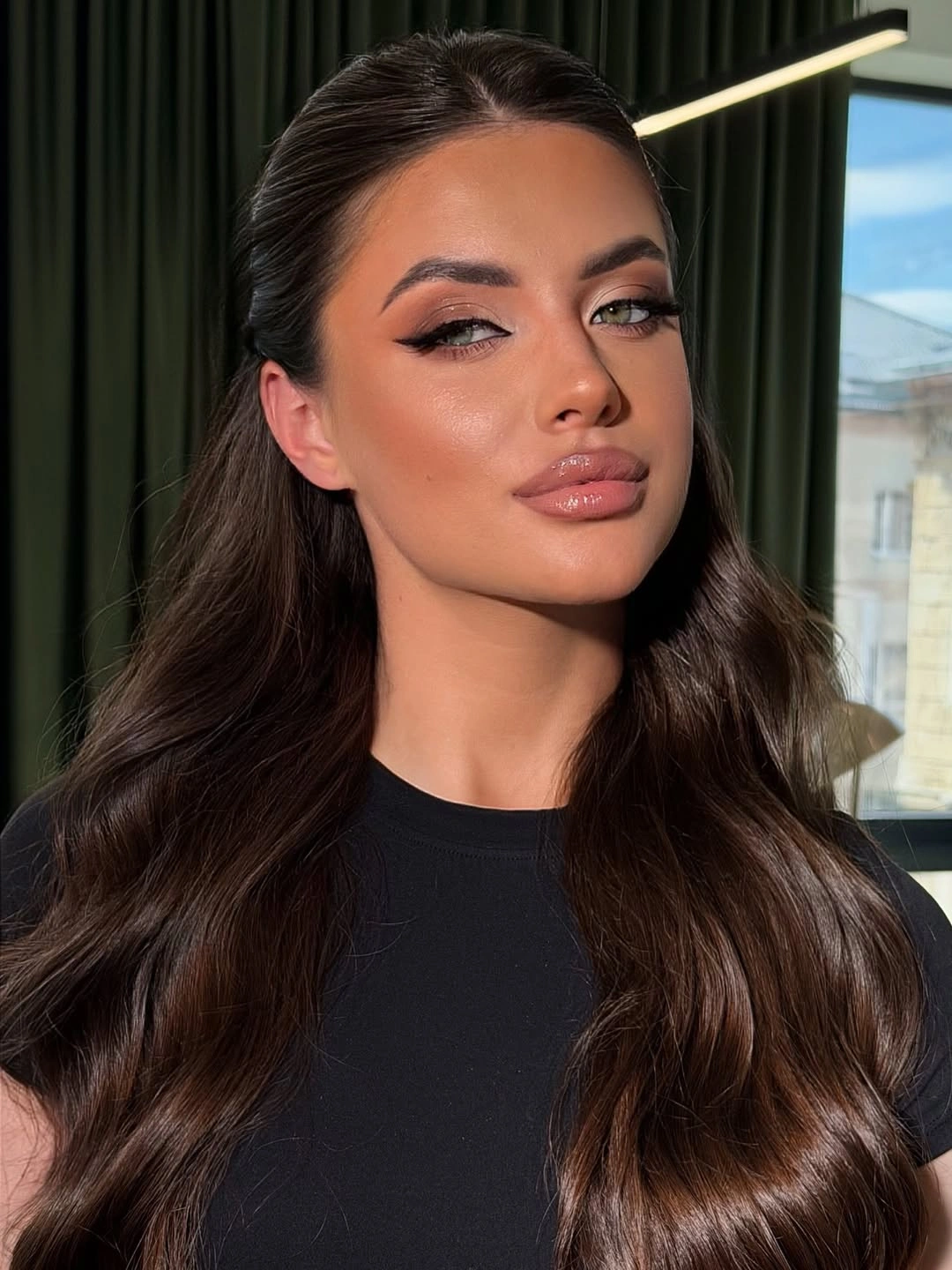 Dark center-parted hair with smooth crown and soft bends