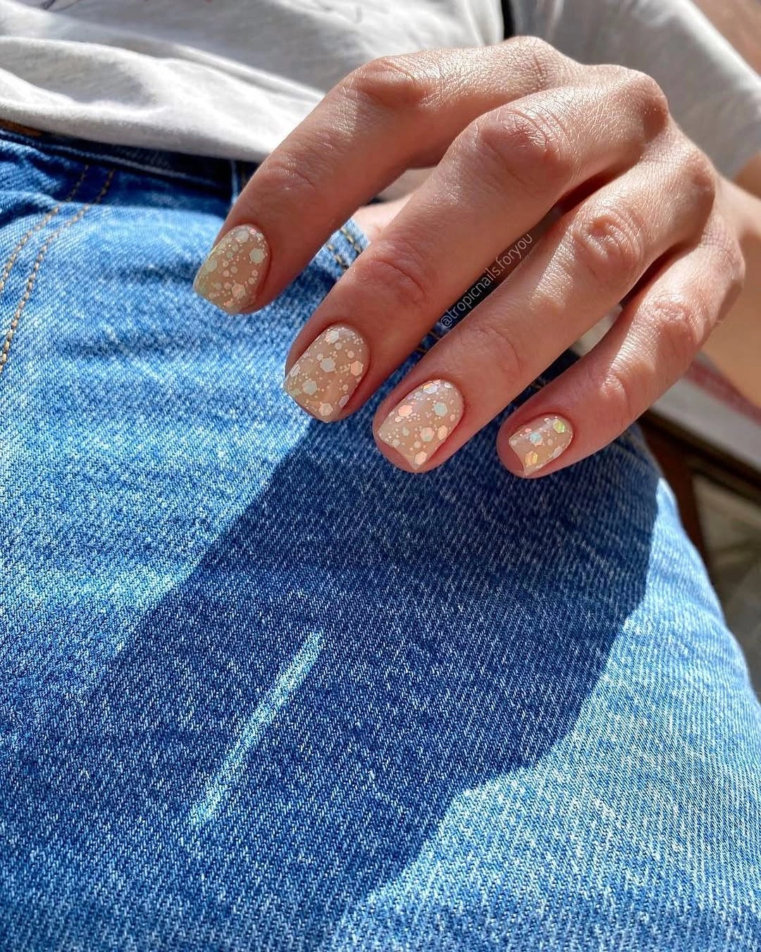 Medium square warm nude nails with fine shimmer and tiny dots