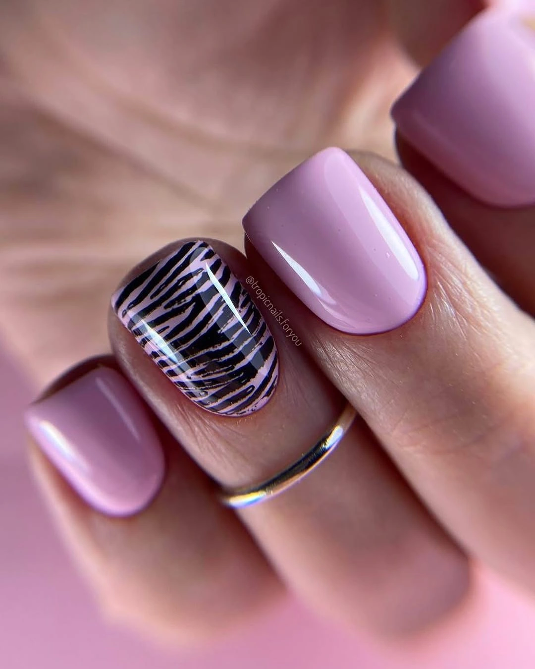 Short square lavender nails with black and white accent stripes