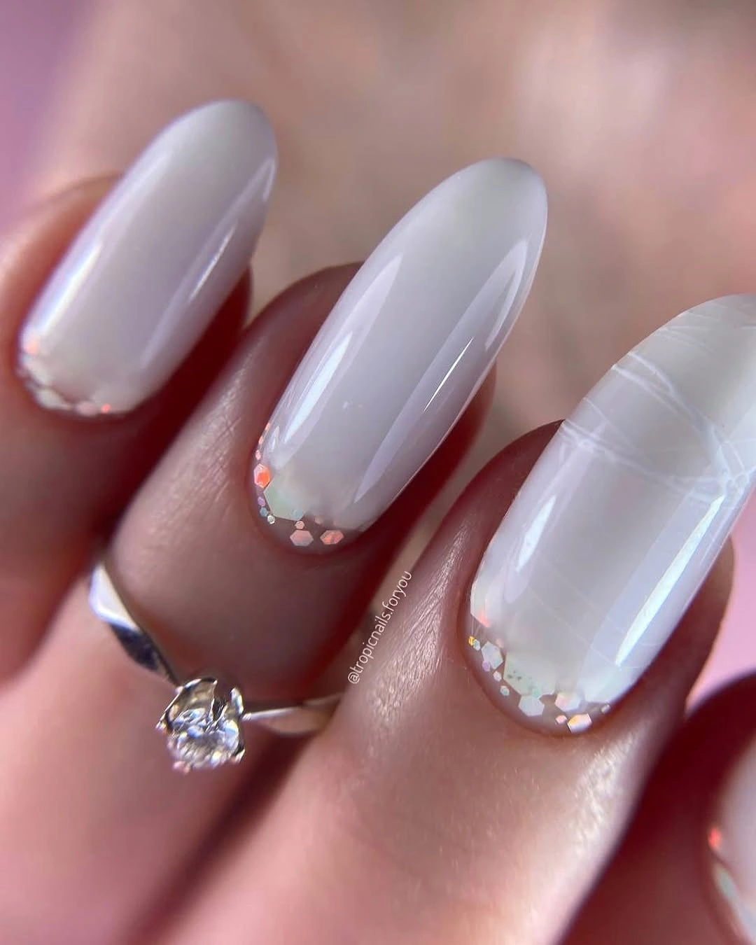 Long almond milky nails with fine white lines and accents