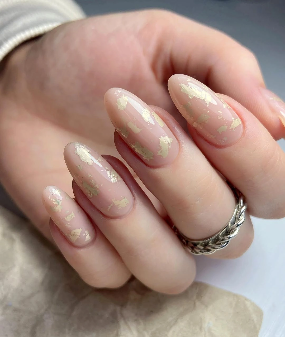 Short rounded blush nails with delicate warm flecks