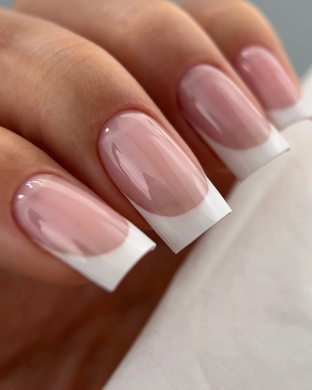 Medium square sheer pink nails with crisp white French tips