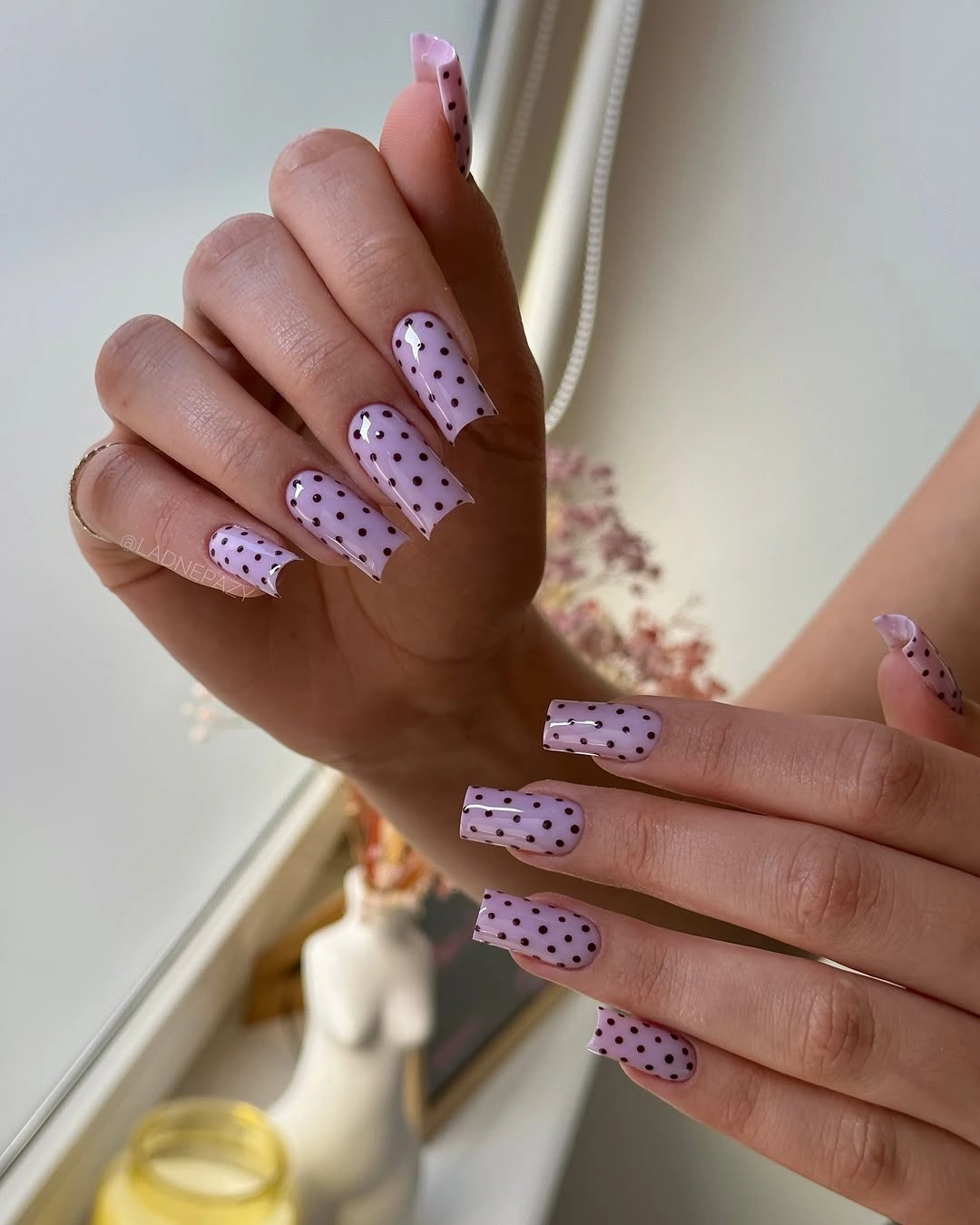 Long lavender square nails with small dark polka dots