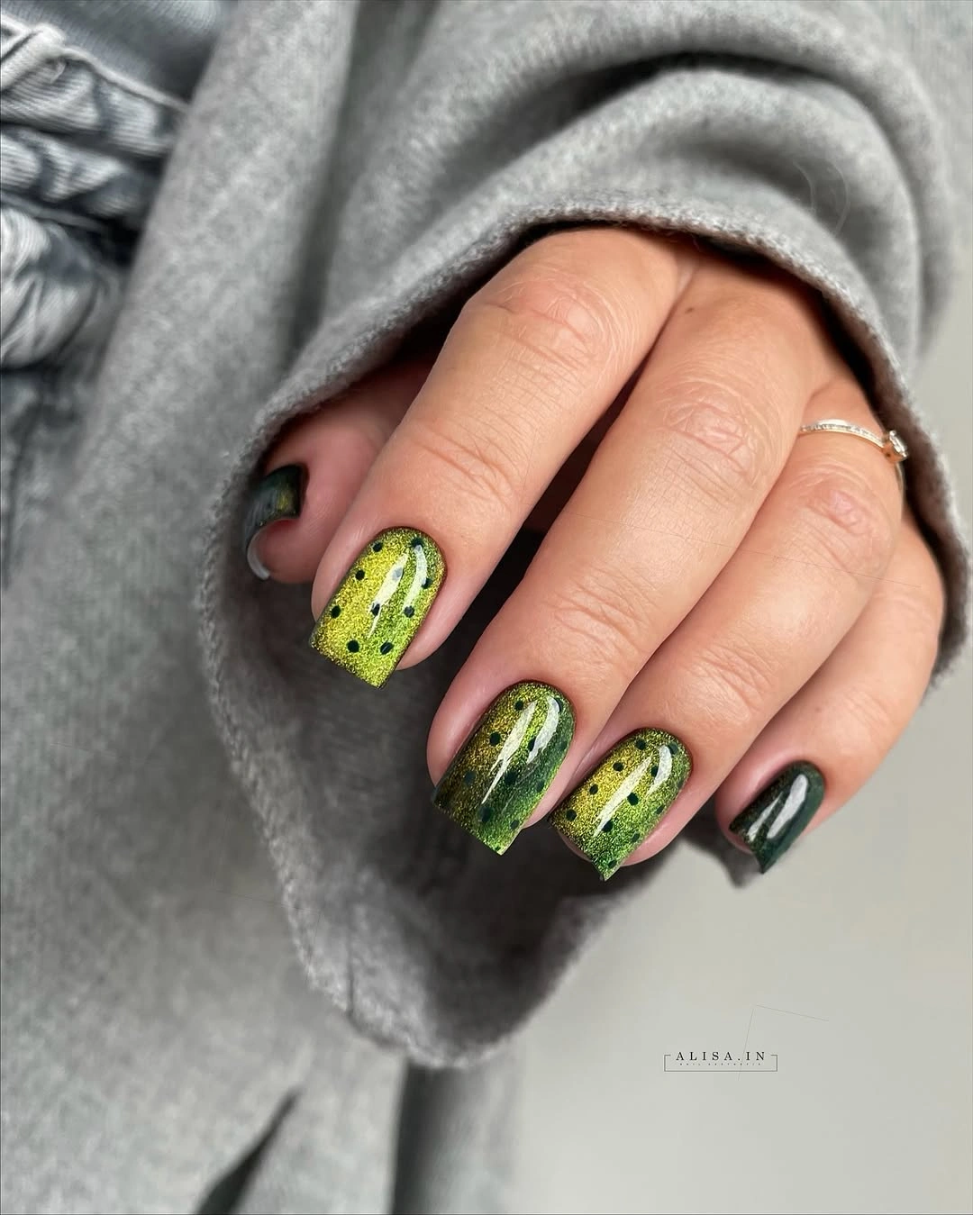 Short green square nails with dark spotted graphic accents