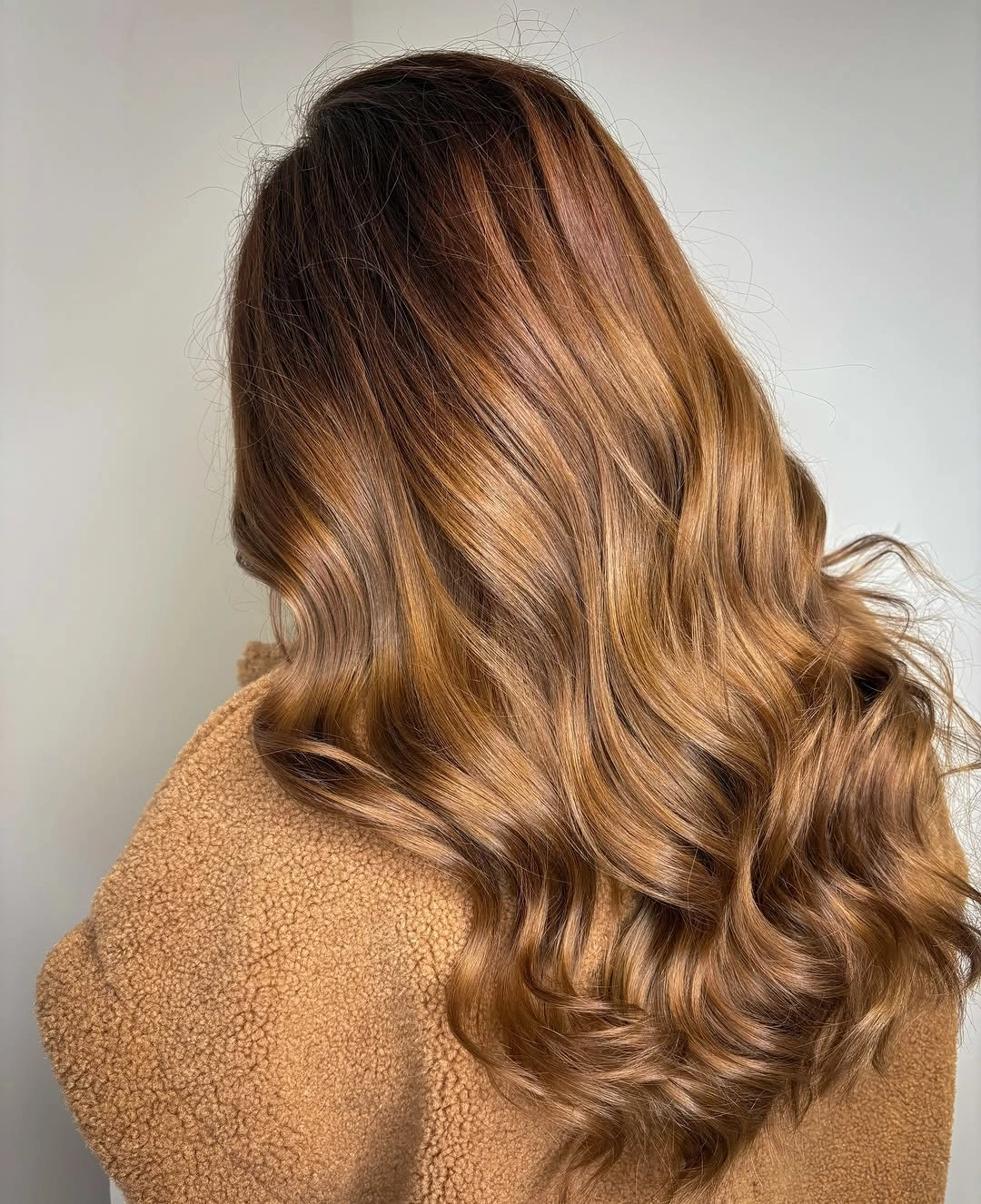 Long golden brown hair with lighter ribbons and polished curls