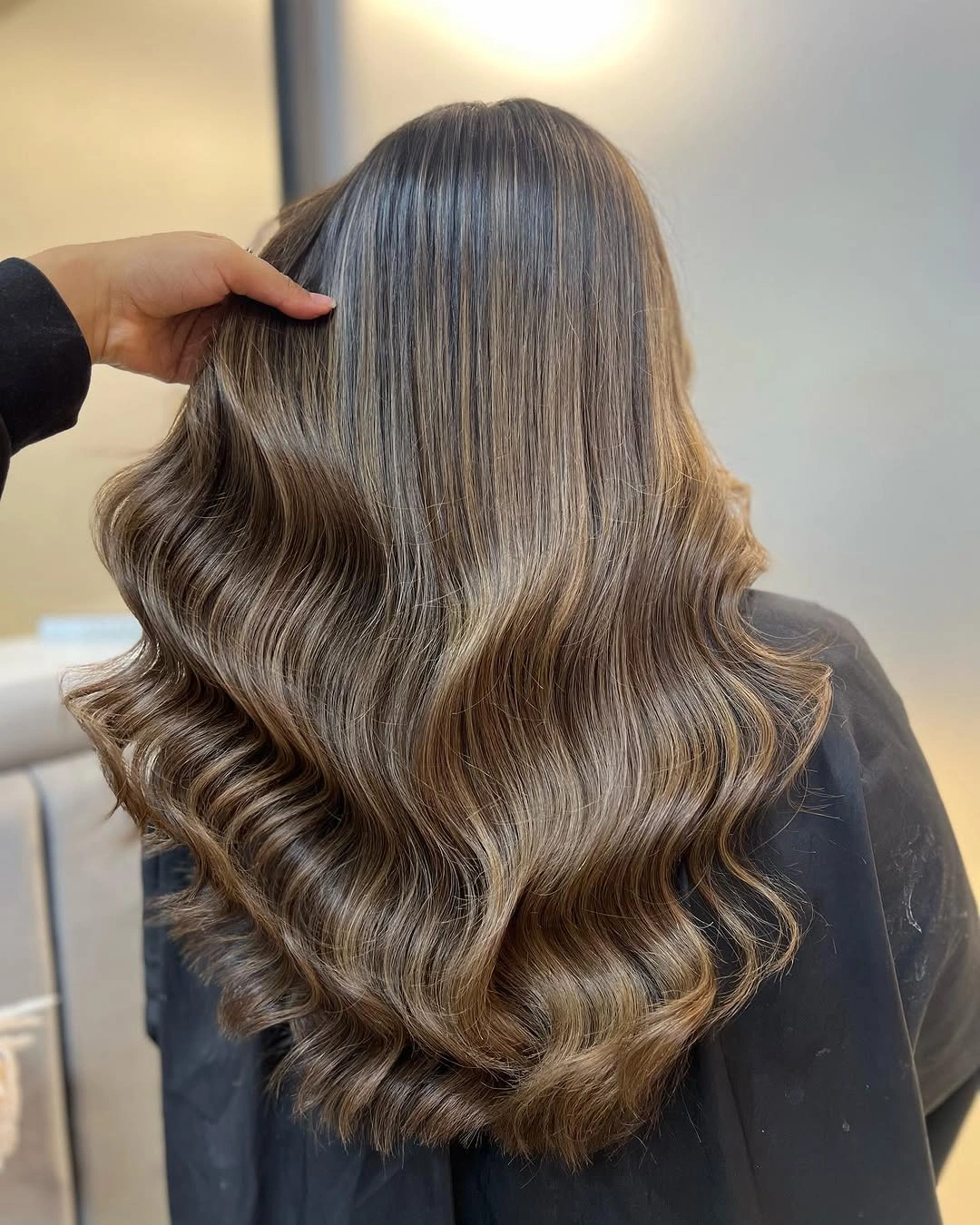 Long cool ash brown hair with broad soft waves