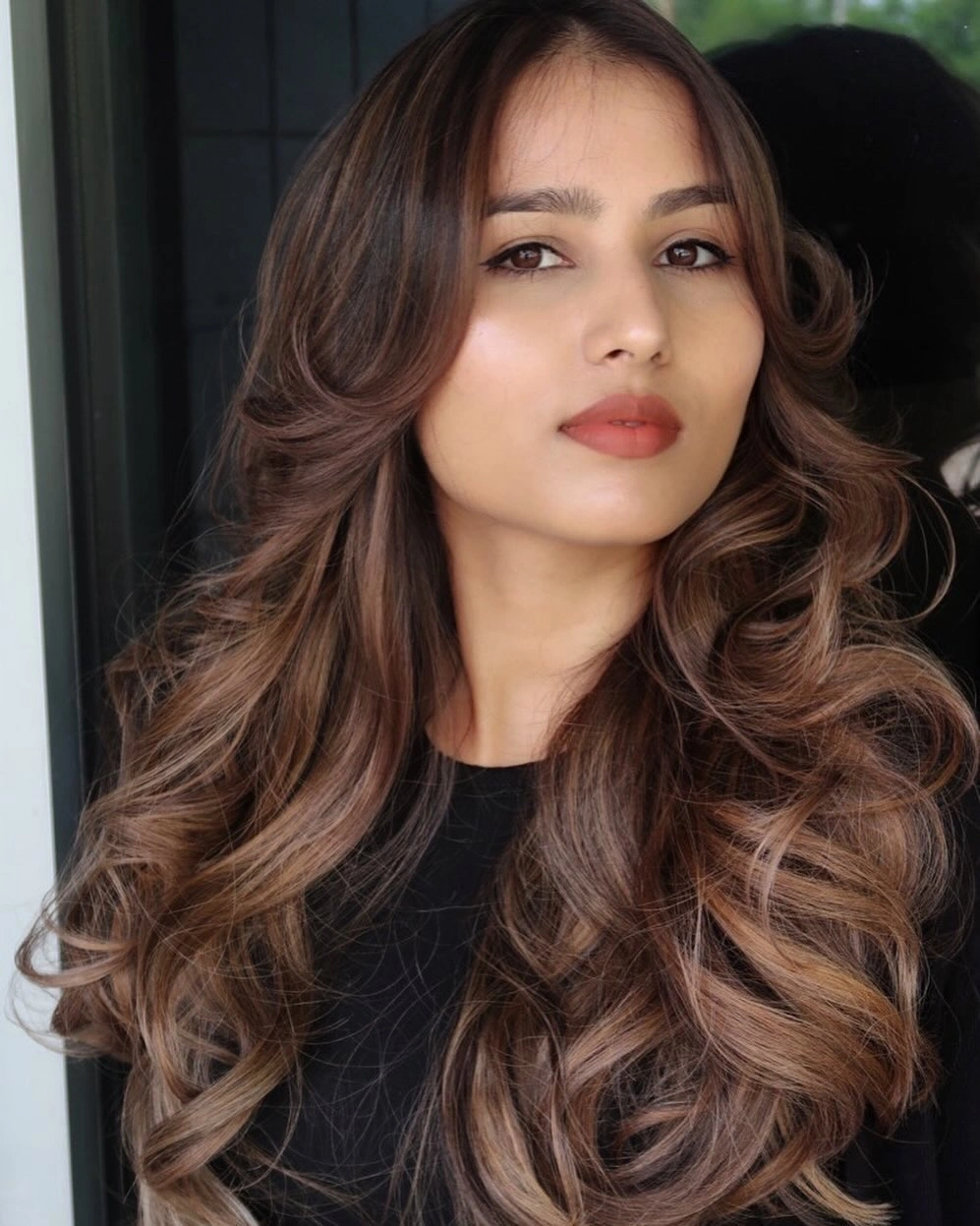 Long dark brunette hair with layered face framing waves
