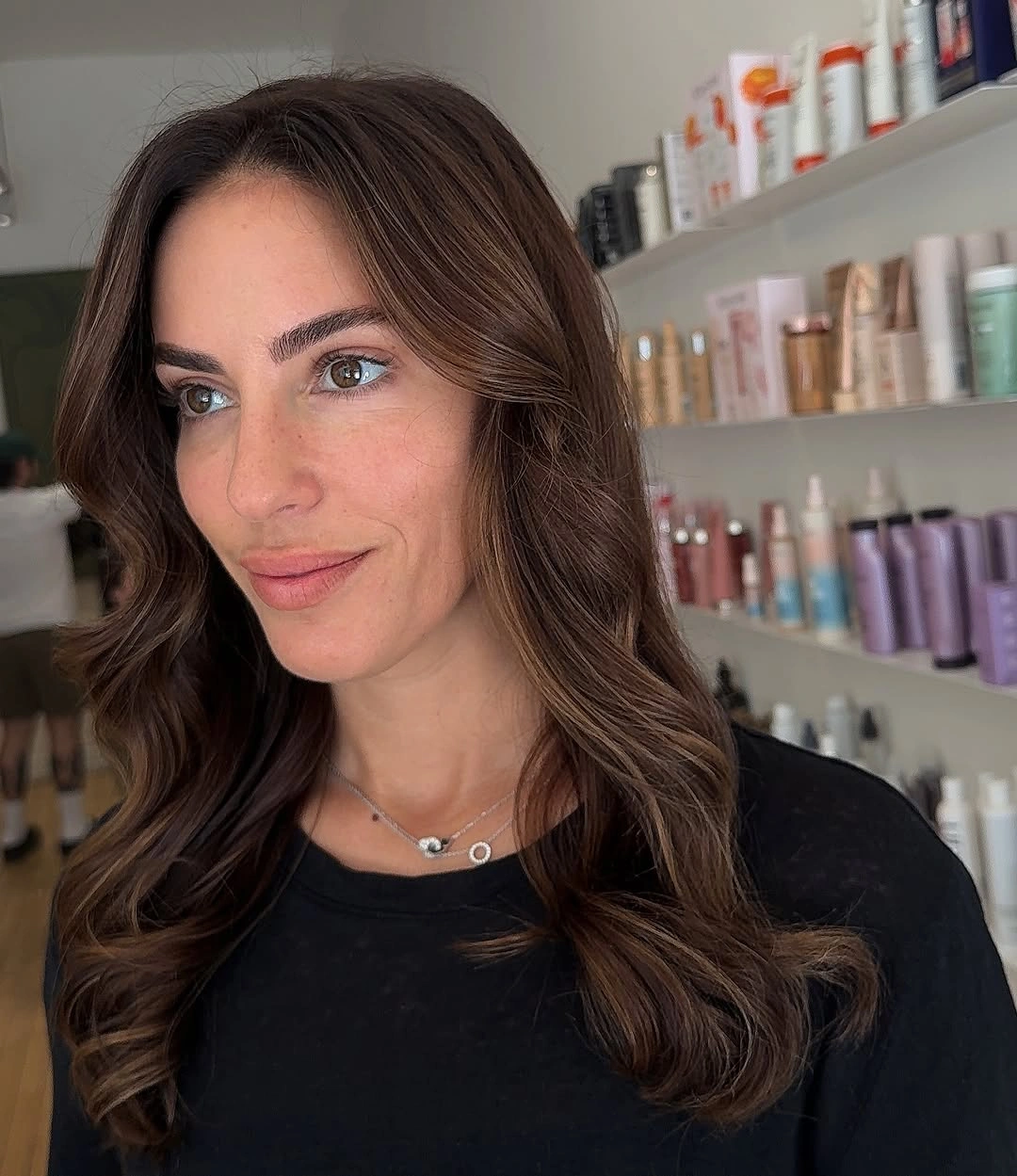 Long dark brunette hair with center part and soft rounded waves