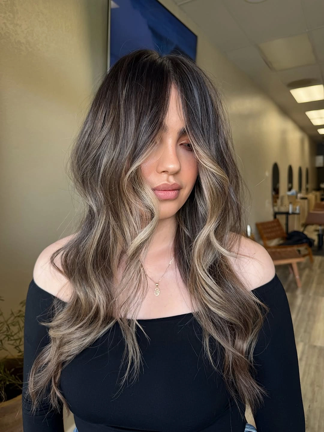 Ash brown waves with cool blonde face framing ribbons