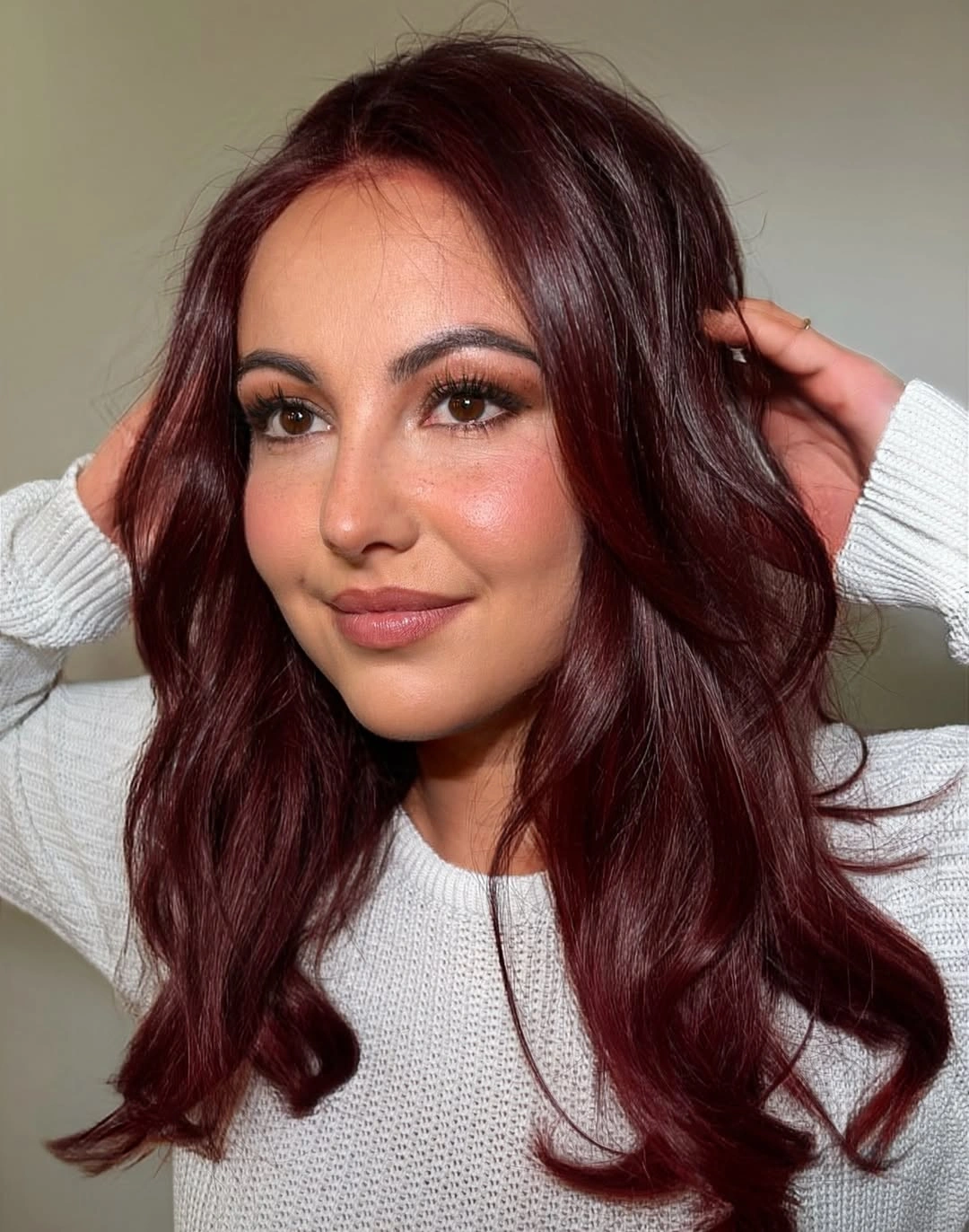 Long deep burgundy hair with soft face framing waves