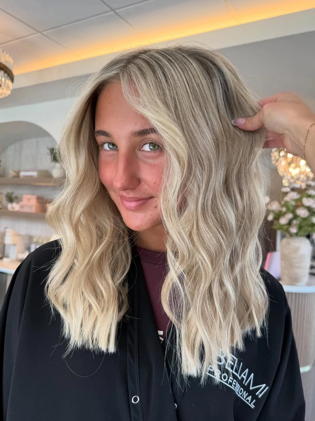 Long light blonde hair with middle part and face framing waves